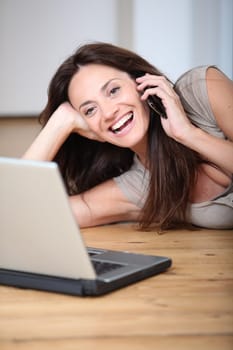 Woman talking on mobile phone at home