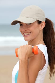 Woman doing exercises on the beach