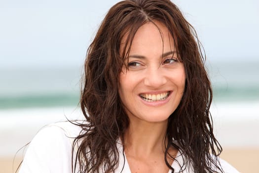 Happy woman on the beach during spa treatment