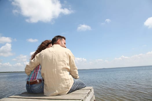 Couple relaxing on a pontoon