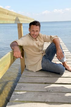 Man on a pontoon by a lake in summer