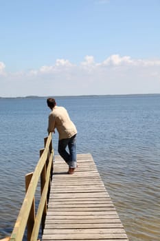 Man on a pontoon by a lake in summer