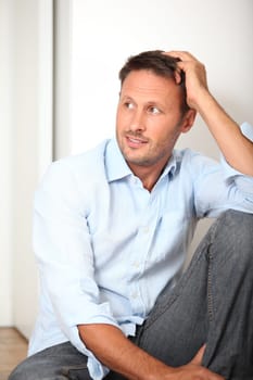Closeup of man sitting on the floor at home