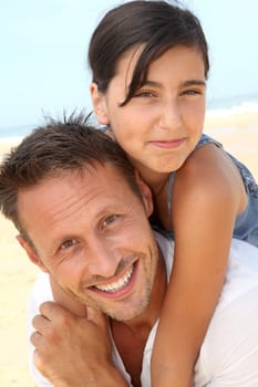 Closeup of father and daughter at the beach