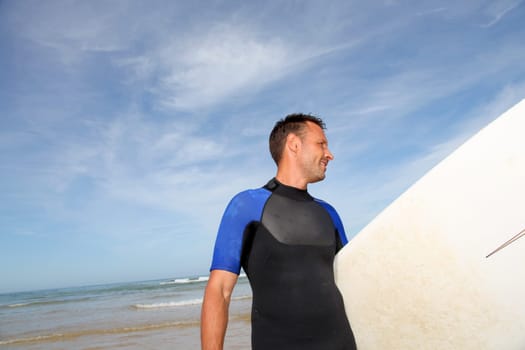 Man holding surfboard at the beach