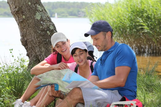Family resting in the grass on a hiking day