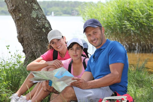 Family resting in the grass on a hiking day