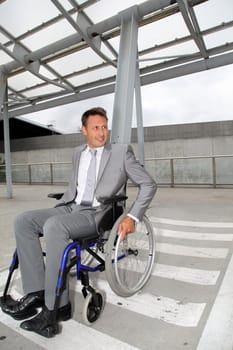Businessman in wheelchair waiting for a taxi