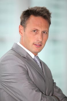 Portrait of businessman in grey suit