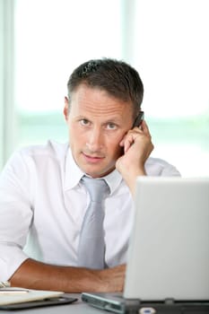 Businessman talking on the phone in the office