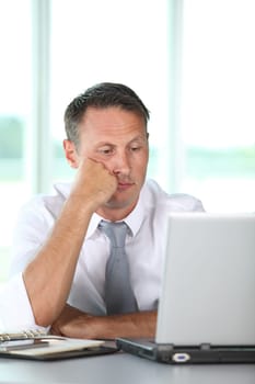 Bored businessman in front of computer