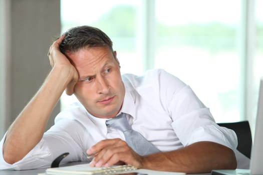 Businessman spending long hours in the office