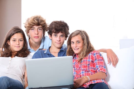Group of teenagers at home with laptop