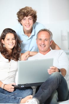 Family at home with laptop computer