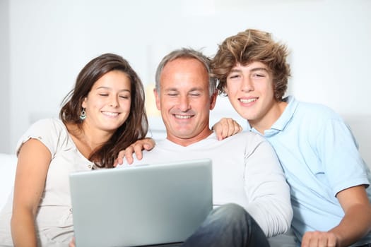 Family at home with laptop computer