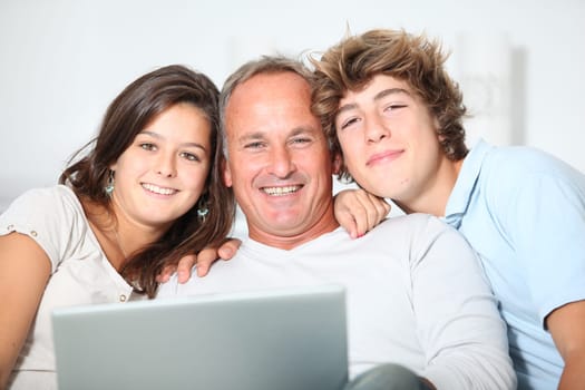 Family at home with laptop computer