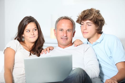 Family at home with laptop computer