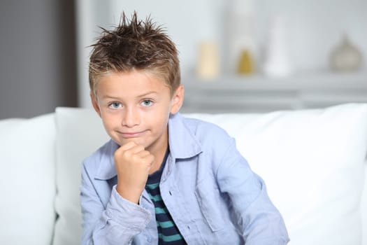 Cute little boy with hand on chin
