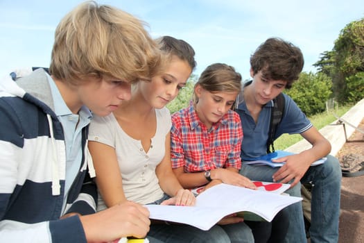 Teenagers studying outside the class