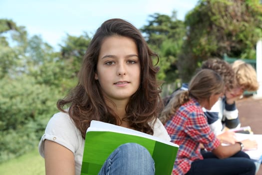 Teenagers studying outside the class