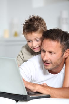 Father and son connected on internet at home