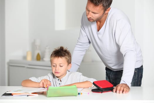 Father helping son to do homework