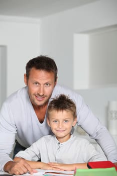 Father helping son to do homework