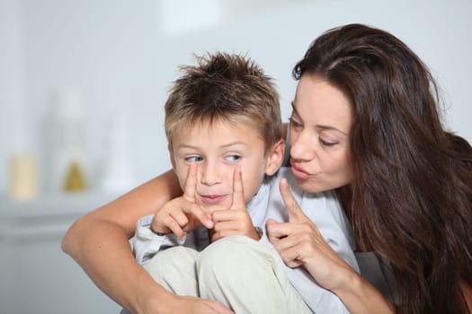 Mother and son having fun at home