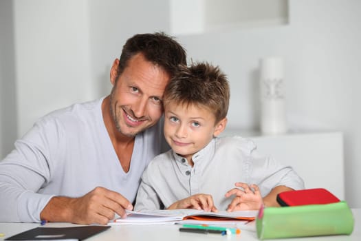 Father helping son to do homework