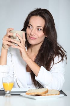 Beautiful woman having breakfast at home