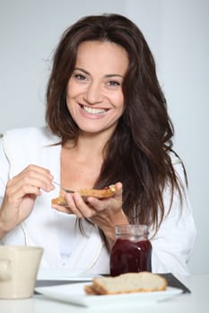 Beautiful woman having breakfast at home