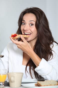 Beautiful woman having breakfast at home