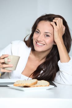 Beautiful woman having breakfast at home
