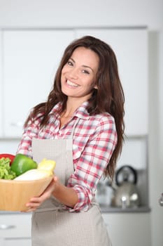 Beautiful woman stading in kitchen with apron