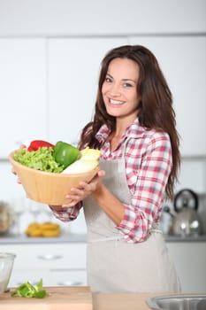 Beautiful woman stading in kitchen with apron