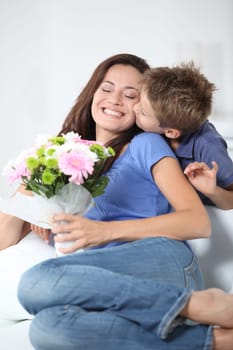 Little boy kissing his mom on mother's day