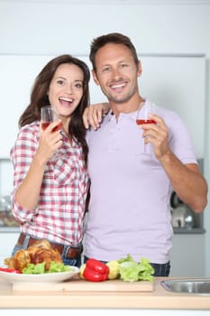 Couple drinking wine while fixing dinner