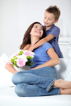 Little boy giving flowers to his mom on mother's day