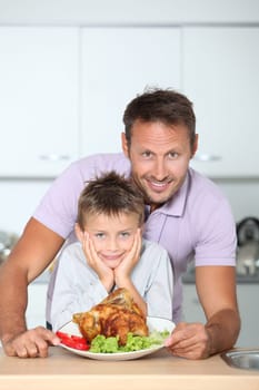 Father and son fixing dinner