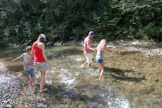 Family crossing a river