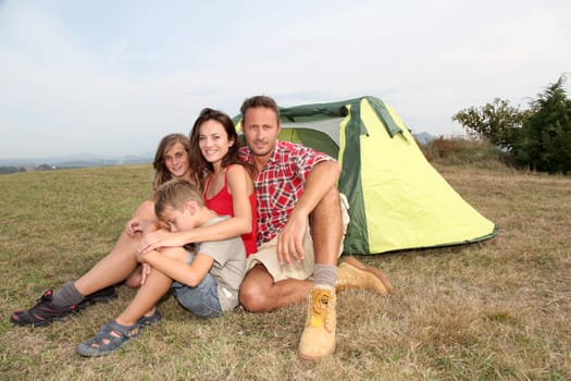 Parents and children in camp tent