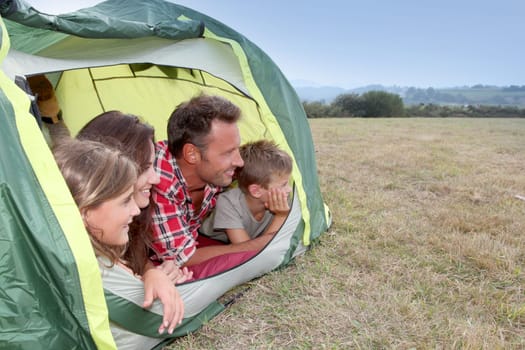 Parents and children in camp tent
