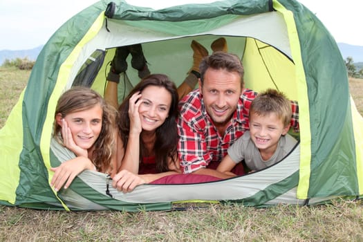 Parents and children in camp tent