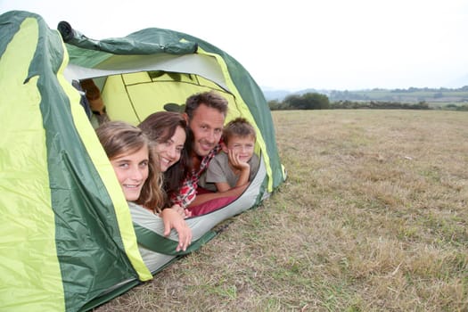 Parents and children in camp tent