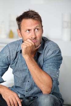 Closeup of man sitting in sofa