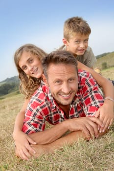 Closeup of happy family lying in grass