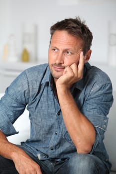 Closeup of man sitting in sofa
