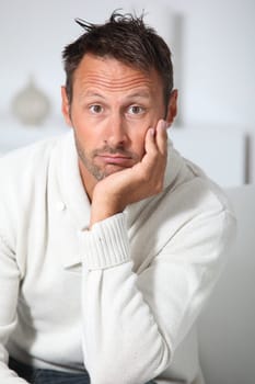 Closeup of hansdsome man with white sweater