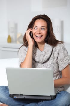 Woman on sofa with laptop computer
