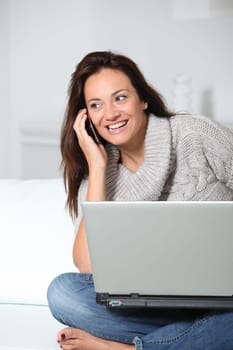 Woman on sofa with laptop computer